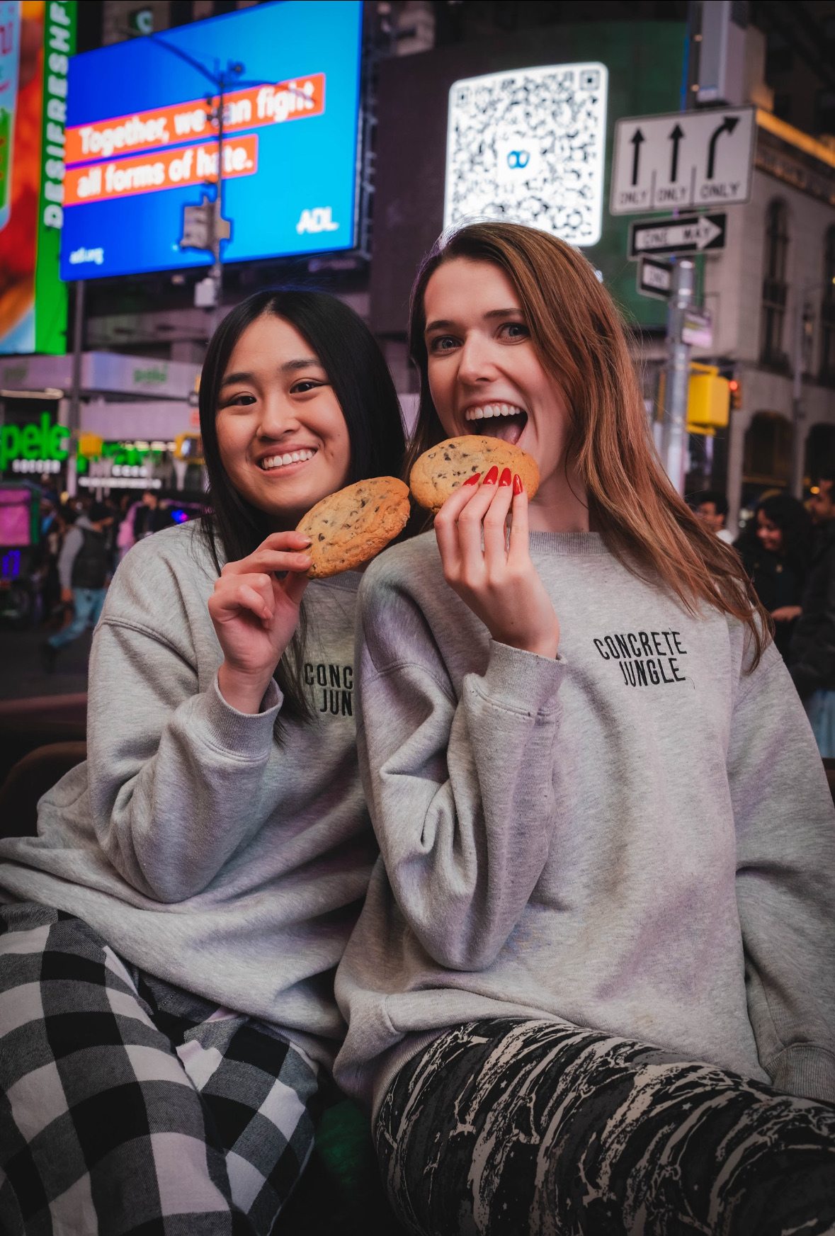 Erika and a friend laughing with cookies in Times Square