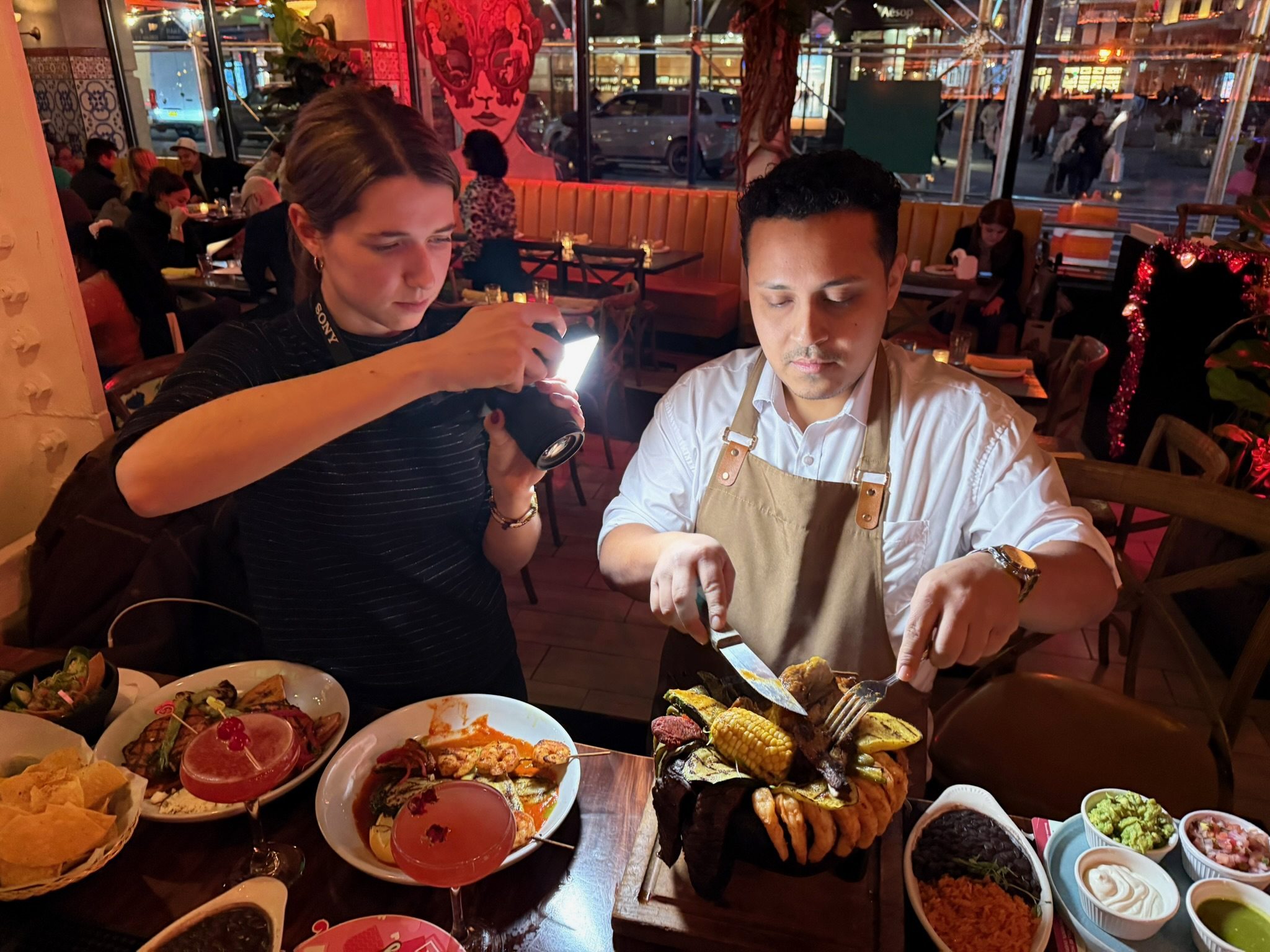 Erika lighting a chef’s plate during a restaurant shoot